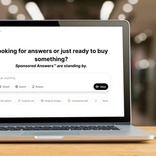 Laptop screen displaying ChatGPT interface with the message: 'Looking for answers or just ready to buy something? Sponsored answers™ are standing by.'