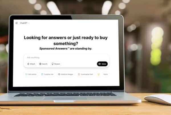 Laptop screen displaying ChatGPT interface with the message: 'Looking for answers or just ready to buy something? Sponsored answers™ are standing by.'